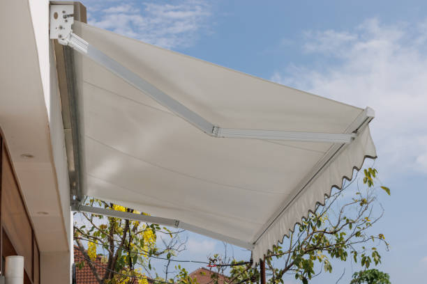 Jasa Kanopi Kain white awning roof against with blue sky. canvas roof sun protection of store.