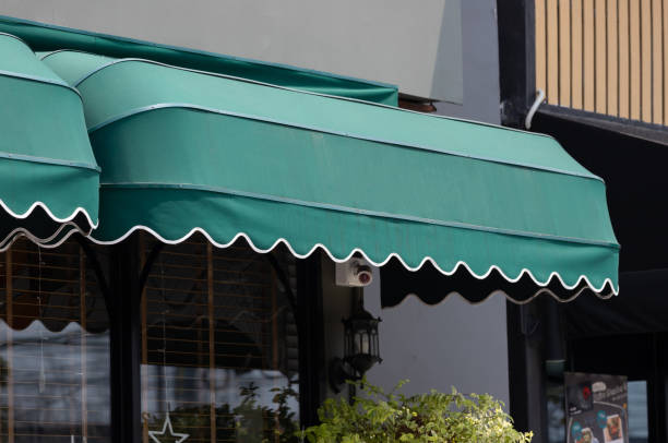 Jasa Kanopi Kain green curve awning of shop window. exterior canvas roof.