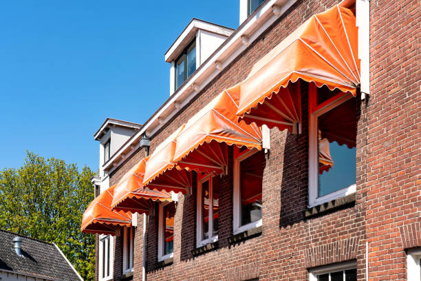 Jasa Kanopi Kain orange awnings over the windows on a brig facade