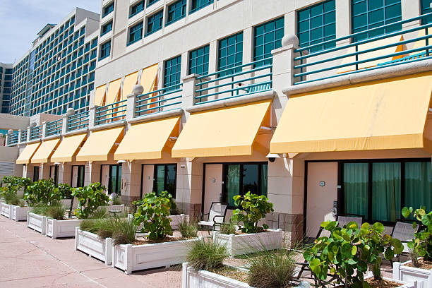 Jasa Kanopi Kain a line of beachside rooms in front of a large tropical resort.