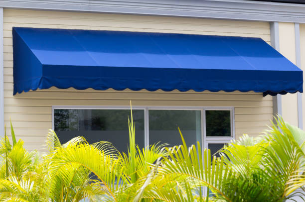 Jasa Kanopi Kain blue awning over white aluminium frame window of shop